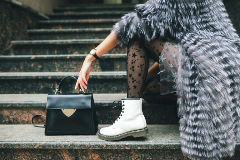 close up legs white boots fashionable woman posing city warm fur coat with black leather bag 1